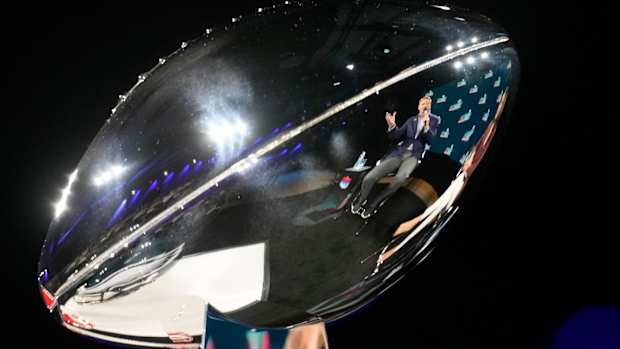Reflected in the Vince Lombardi Trophy, NFL commissioner Roger Goodell answers a question during a news conference at the Phoenix Convention Center on Feb 8, 2023.
